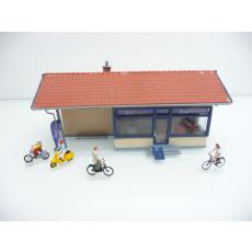 Small commercial building RAD HAUS / bicycle workshop with cyclists and bikers